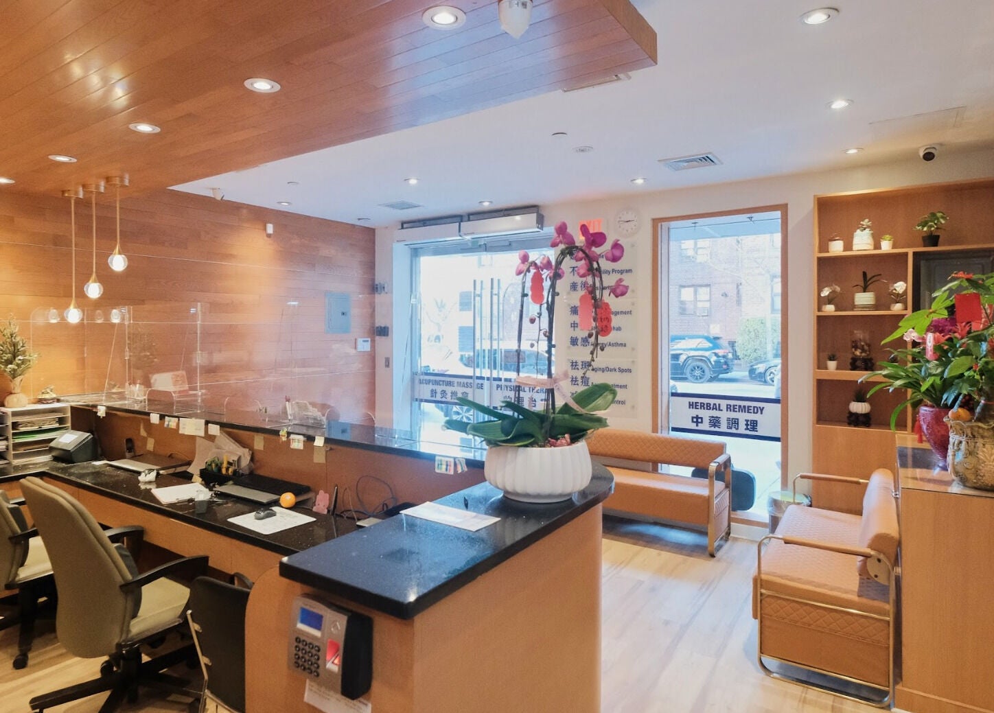 Healthkey Group Wellington - Elmhurst reception area in New York, New York, US, featuring wooden decor and plants.