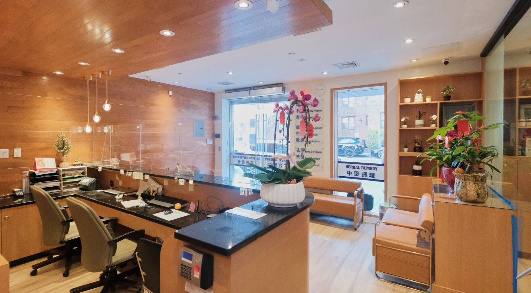 Healthkey Group Wellington - Elmhurst reception area in New York, New York, US, featuring wooden decor and plants.