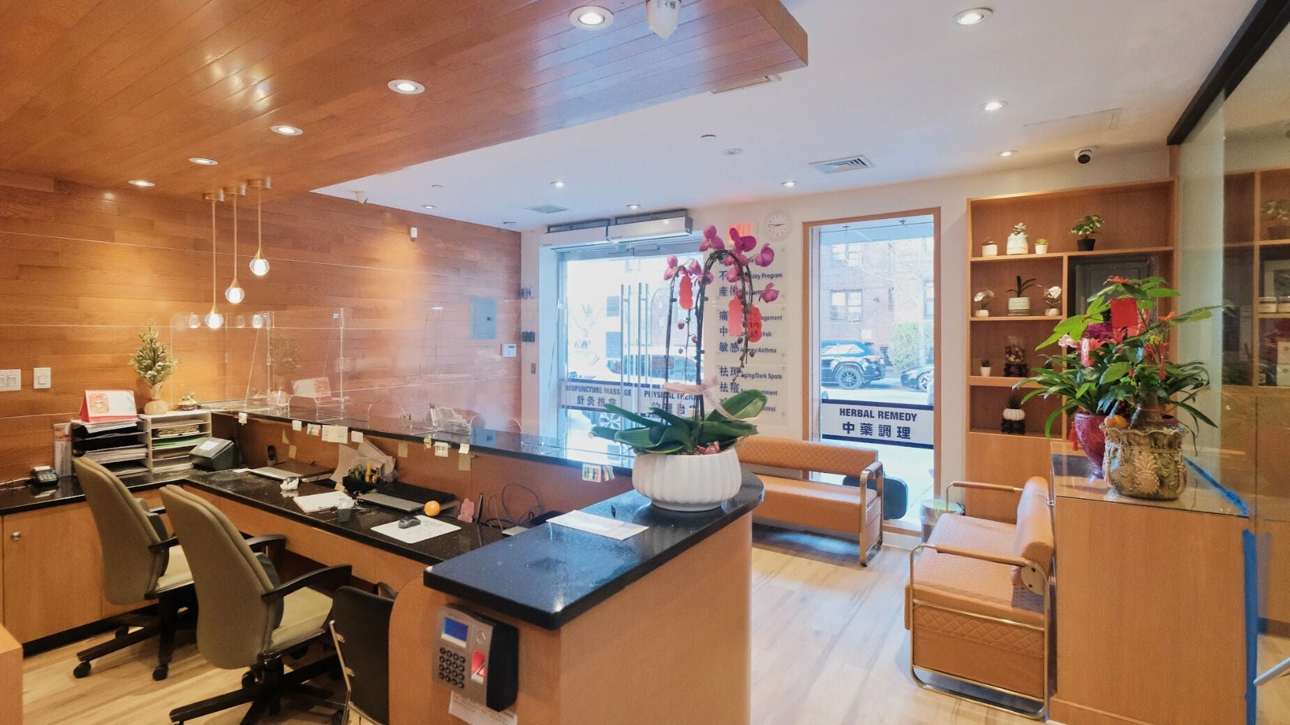Healthkey Group Wellington - Elmhurst reception area in New York, New York, US, featuring wooden decor and plants.