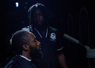 A barber works at Man Cave By Modern Man, Abuja, offering specialized grooming services for men.