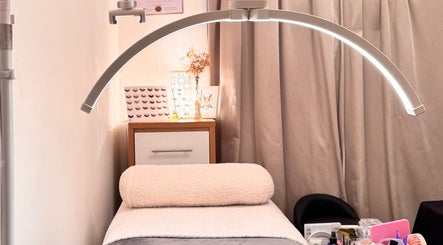 Elegant treatment room at Curl Lashes in Bristol, England, GB with ambient lighting and comfortable bedding.