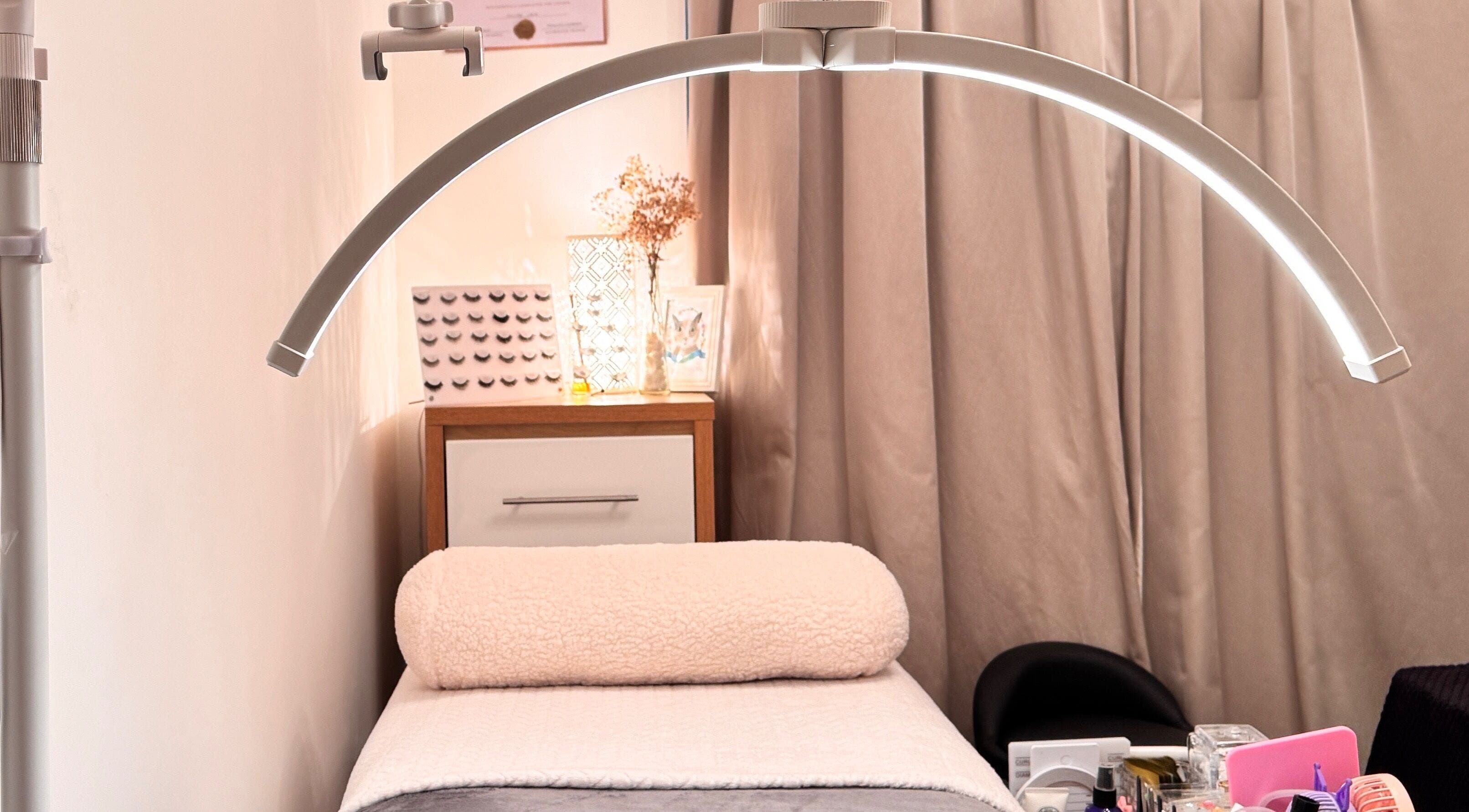 Elegant treatment room at Curl Lashes in Bristol, England, GB with ambient lighting and comfortable bedding.