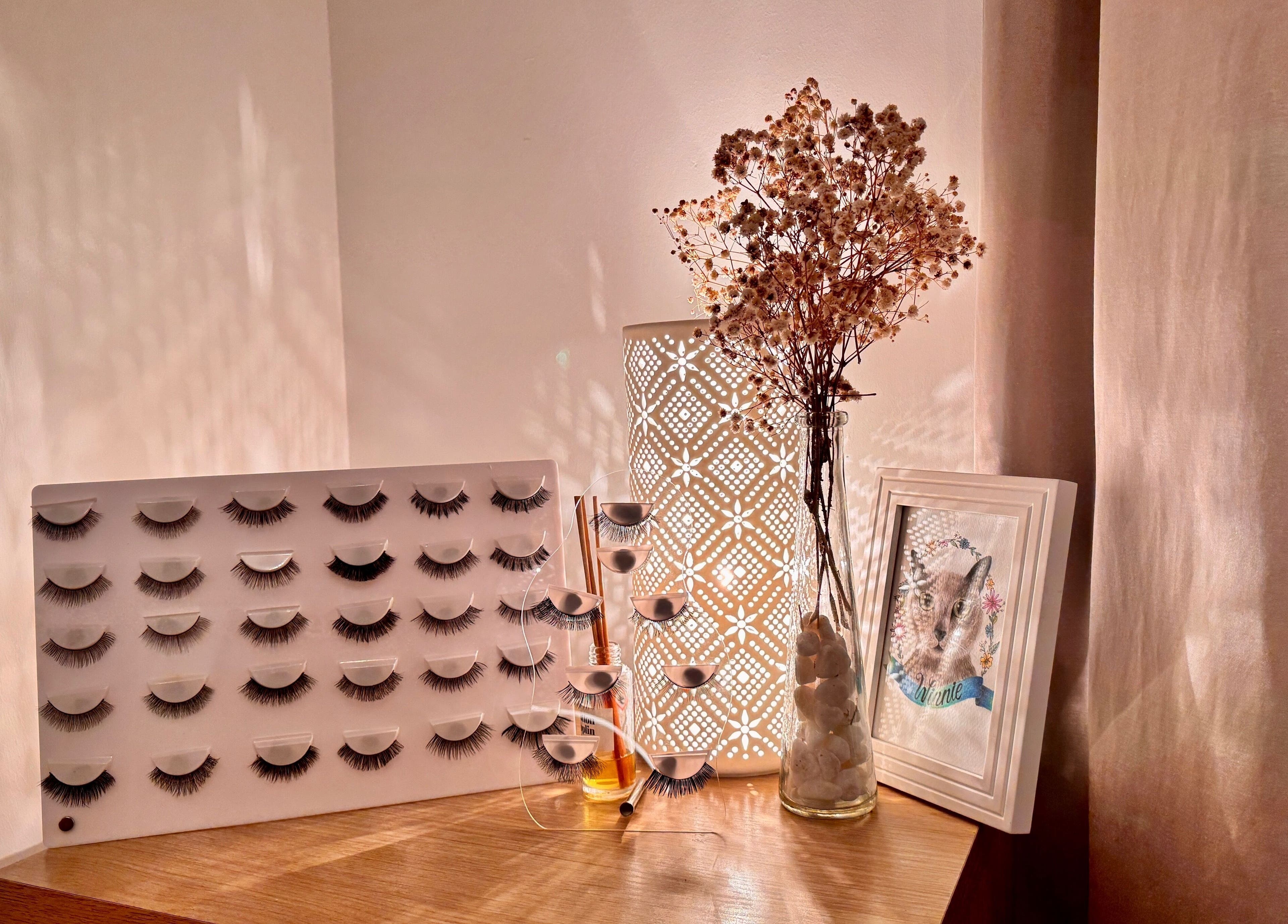 Stylish display of lash extensions at Curl Lashes, Bristol, England, GB, on a wooden table with decor.