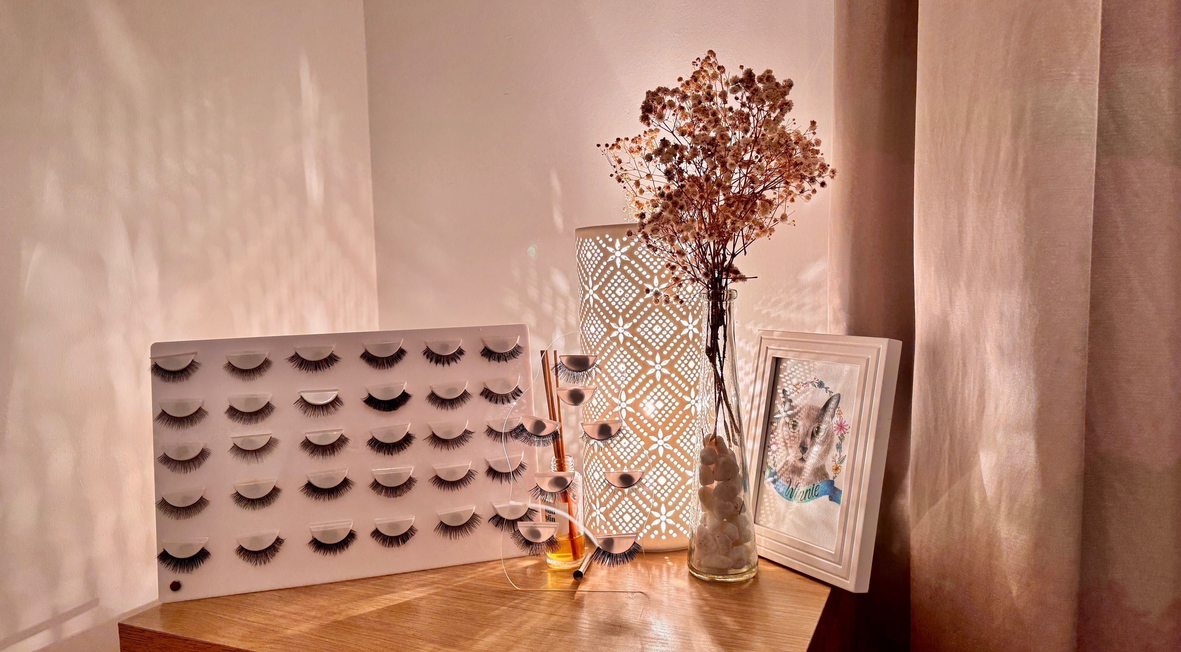 Stylish display of lash extensions at Curl Lashes, Bristol, England, GB, on a wooden table with decor.