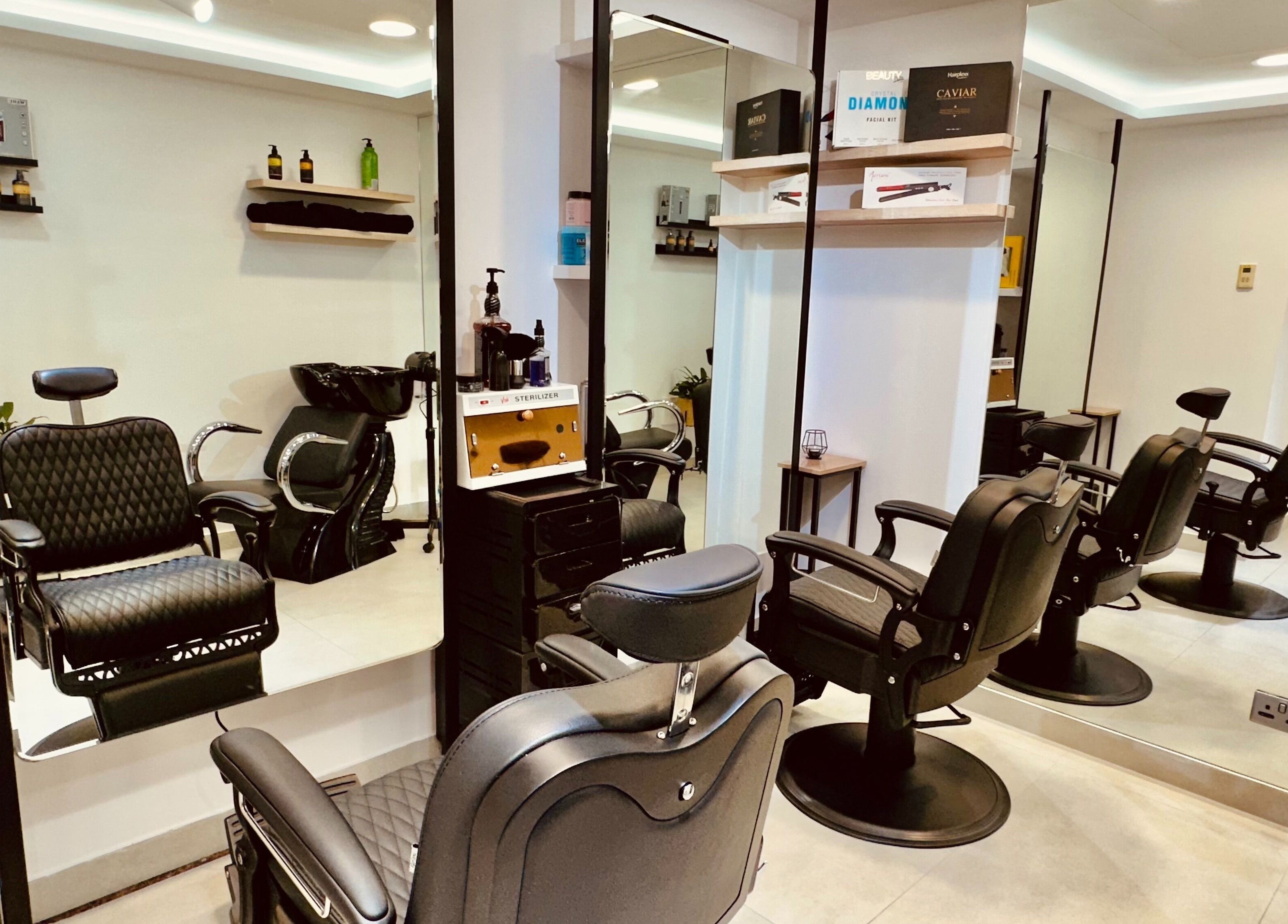 S & J Beauty Salon in دبي, دبي, AE featuring stylish black salon chairs and a modern mirror setup.