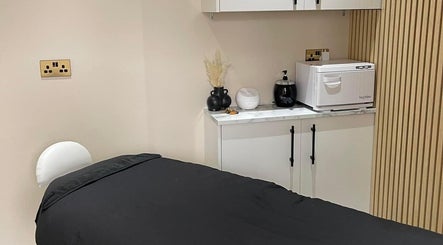 Calming treatment room at The Coven Hair Lounge, Aylesbury, England, GB with a massage bed and soothing decor.