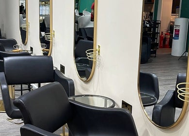 Stylish salon chairs and mirrors at The Coven Hair Lounge, Aylesbury, England, GB.