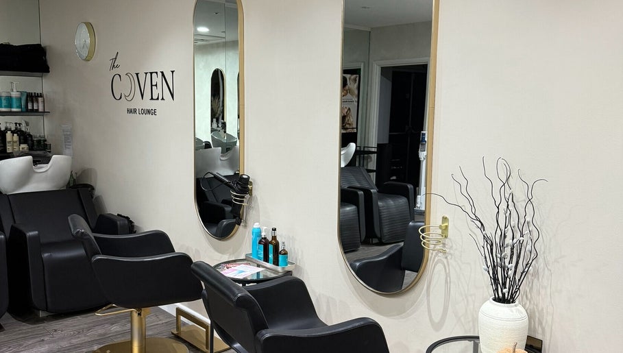 Elegant styling stations at The Coven Hair Lounge, Aylesbury, England, GB, showcasing modern salon design.
