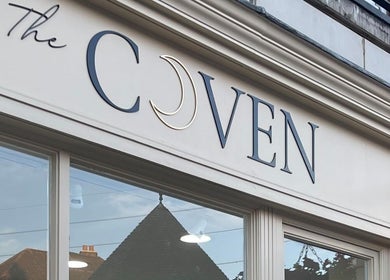 Exterior signage of The Coven Hair Lounge in Aylesbury, England, GB, showcasing elegant design.