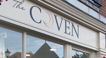 Exterior signage of The Coven Hair Lounge in Aylesbury, England, GB, showcasing elegant design.