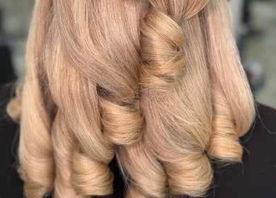 Stunning blonde curls styled at The Coven Hair Lounge, Aylesbury, England, GB, showcasing elegance and volume.