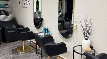 Elegant salon interior with styling stations at The Coven Hair Lounge, Aylesbury, England, GB.
