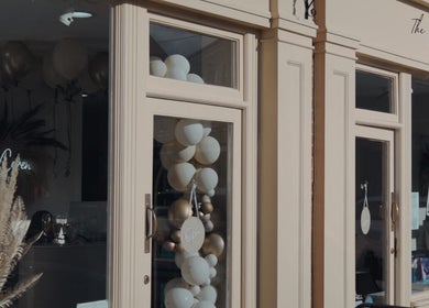 The Coven Hair Lounge facade with elegant balloons in Aylesbury, England, GB.