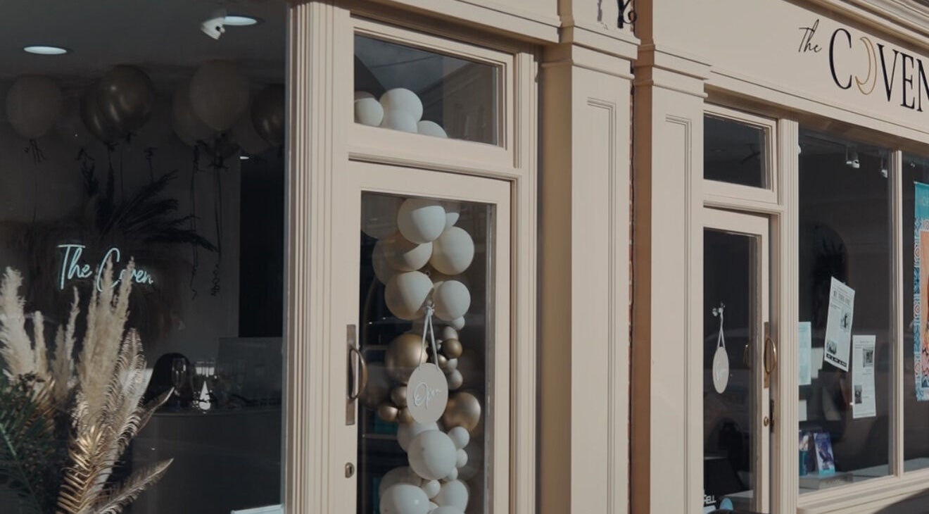 The Coven Hair Lounge facade with elegant balloons in Aylesbury, England, GB.