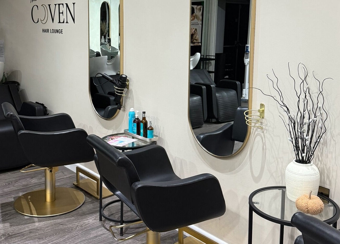 Modern salon chairs and mirrors at The Coven Hair Lounge, Aylesbury, England, GB.