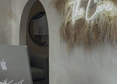 Elegant decor at The Coven Hair Lounge, Aylesbury, England, GB with neon sign and natural textures.