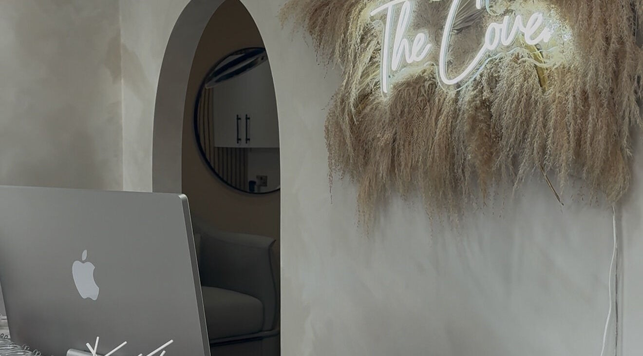 Elegant decor at The Coven Hair Lounge, Aylesbury, England, GB with neon sign and natural textures.