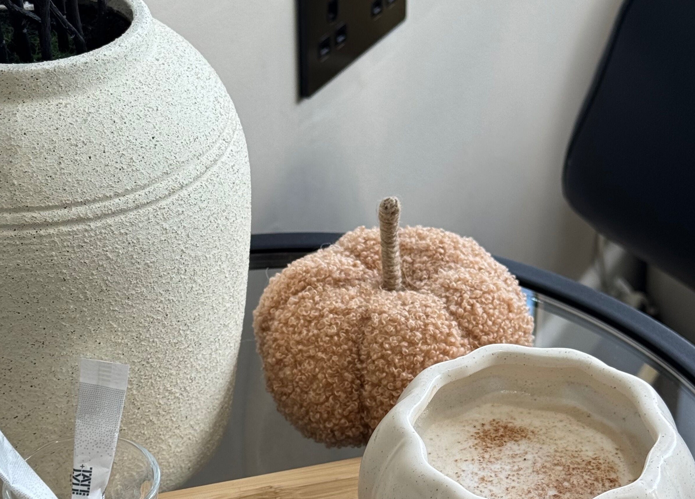 Cozy decor at The Coven Hair Lounge in Aylesbury, England. Features a textured vase and a soft decorative pumpkin.