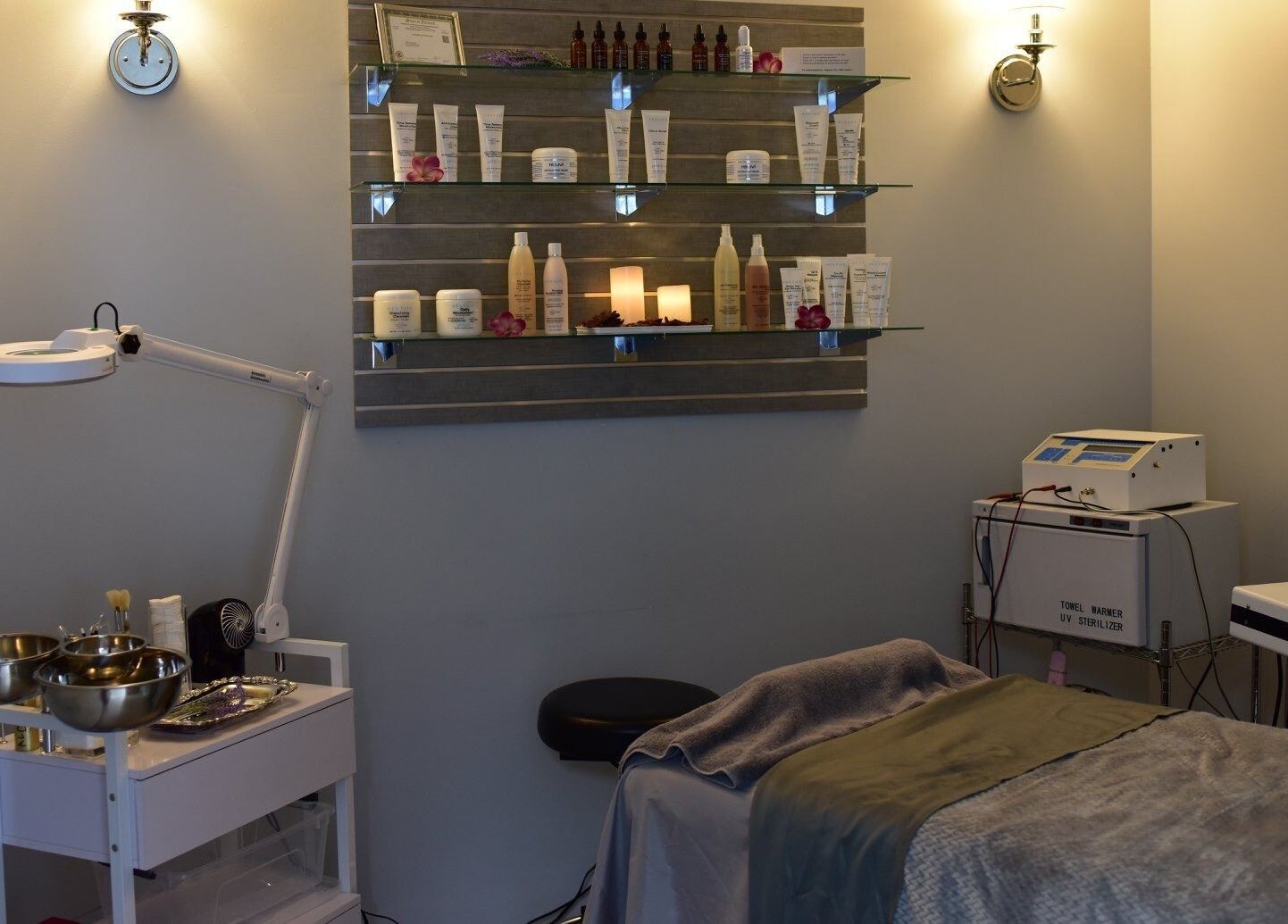 A serene treatment room at Face Reflections, Inc., Bloomingdale, Illinois, US with spa essentials displayed.