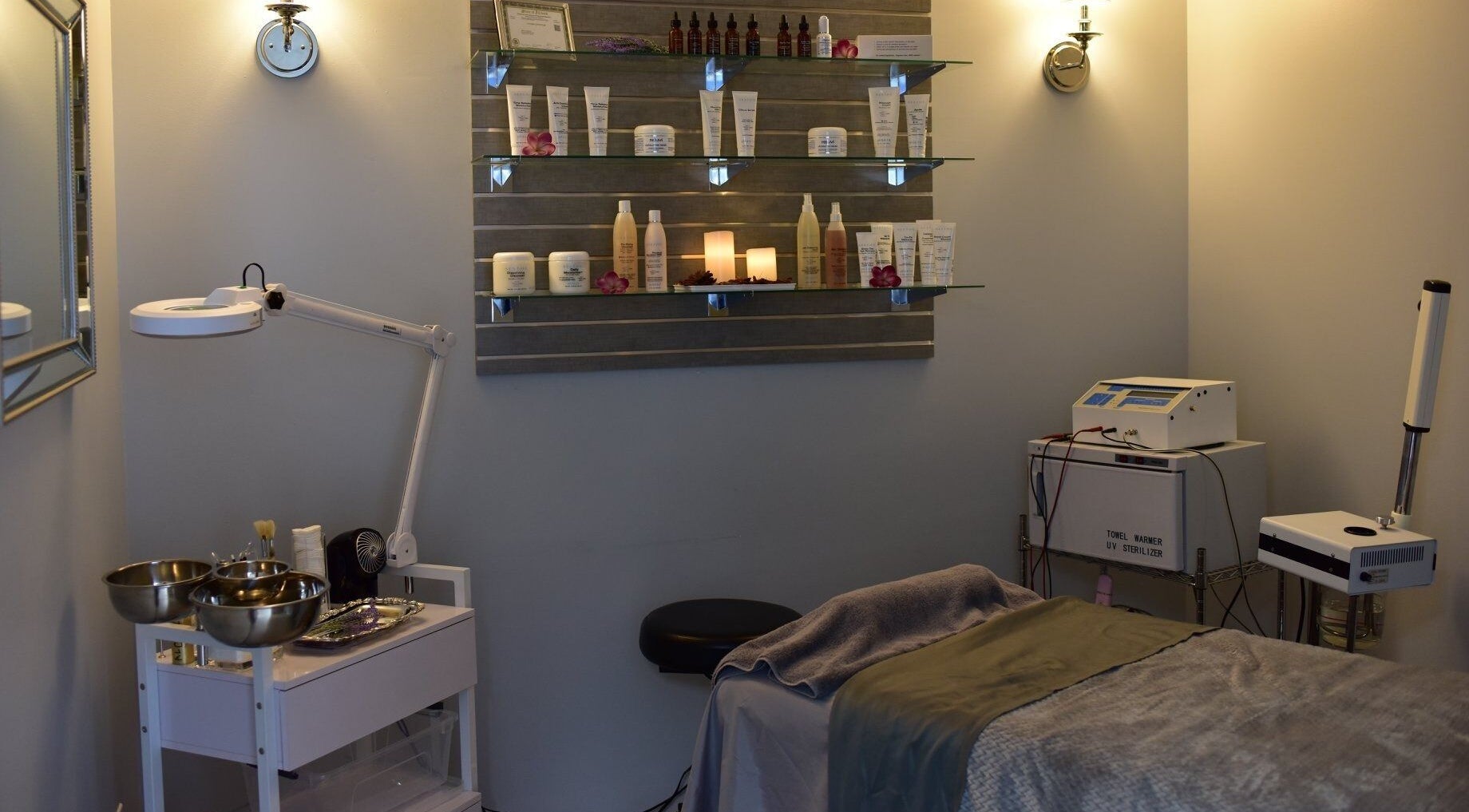 A serene treatment room at Face Reflections, Inc., Bloomingdale, Illinois, US with spa essentials displayed.