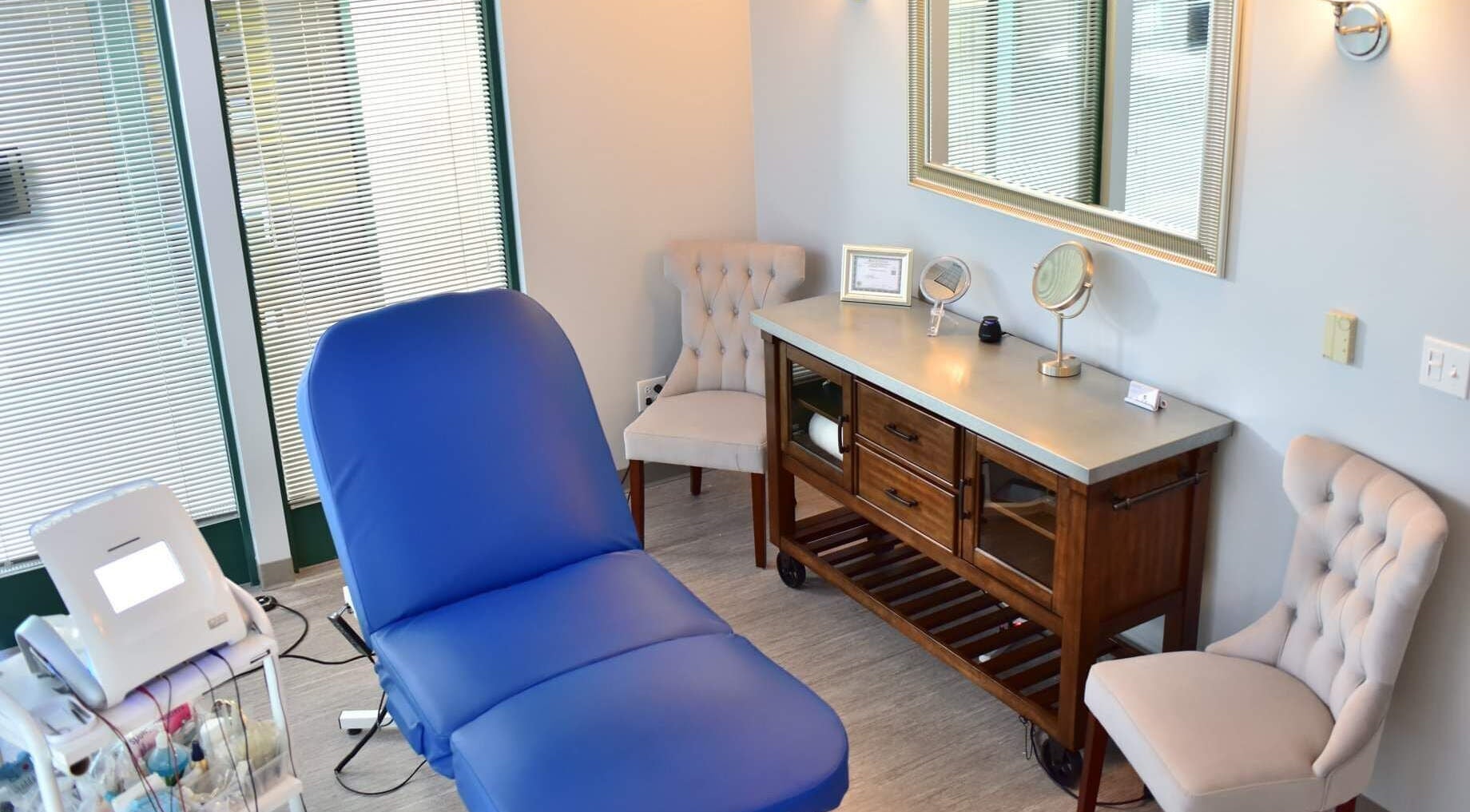 Relaxing treatment room at Face Reflections, Inc. in Bloomingdale, Illinois, US with a spa chair and mirror.