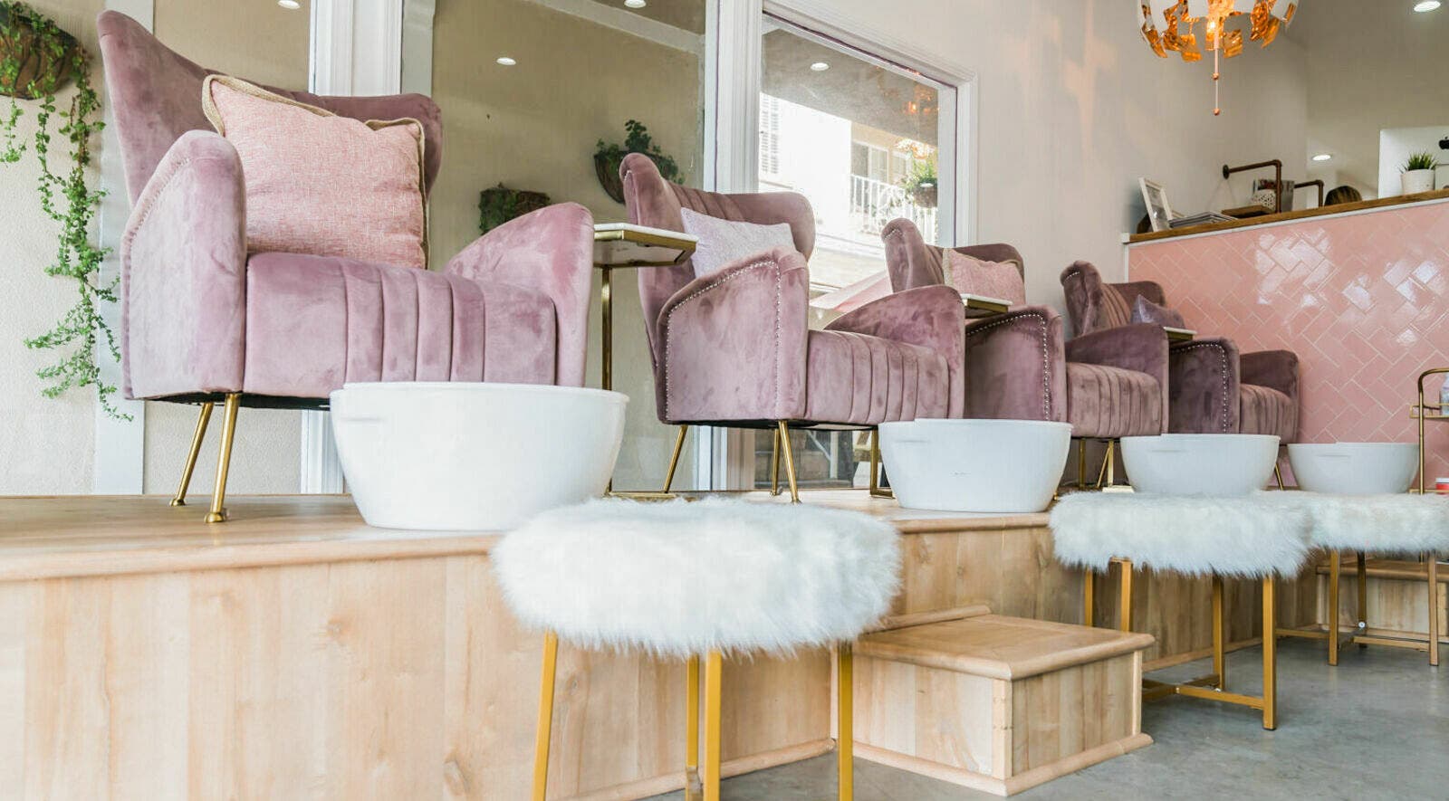 Elegant pink velvet pedicure chairs at Blush LA, Los Angeles, California, US with plush seating and modern decor.