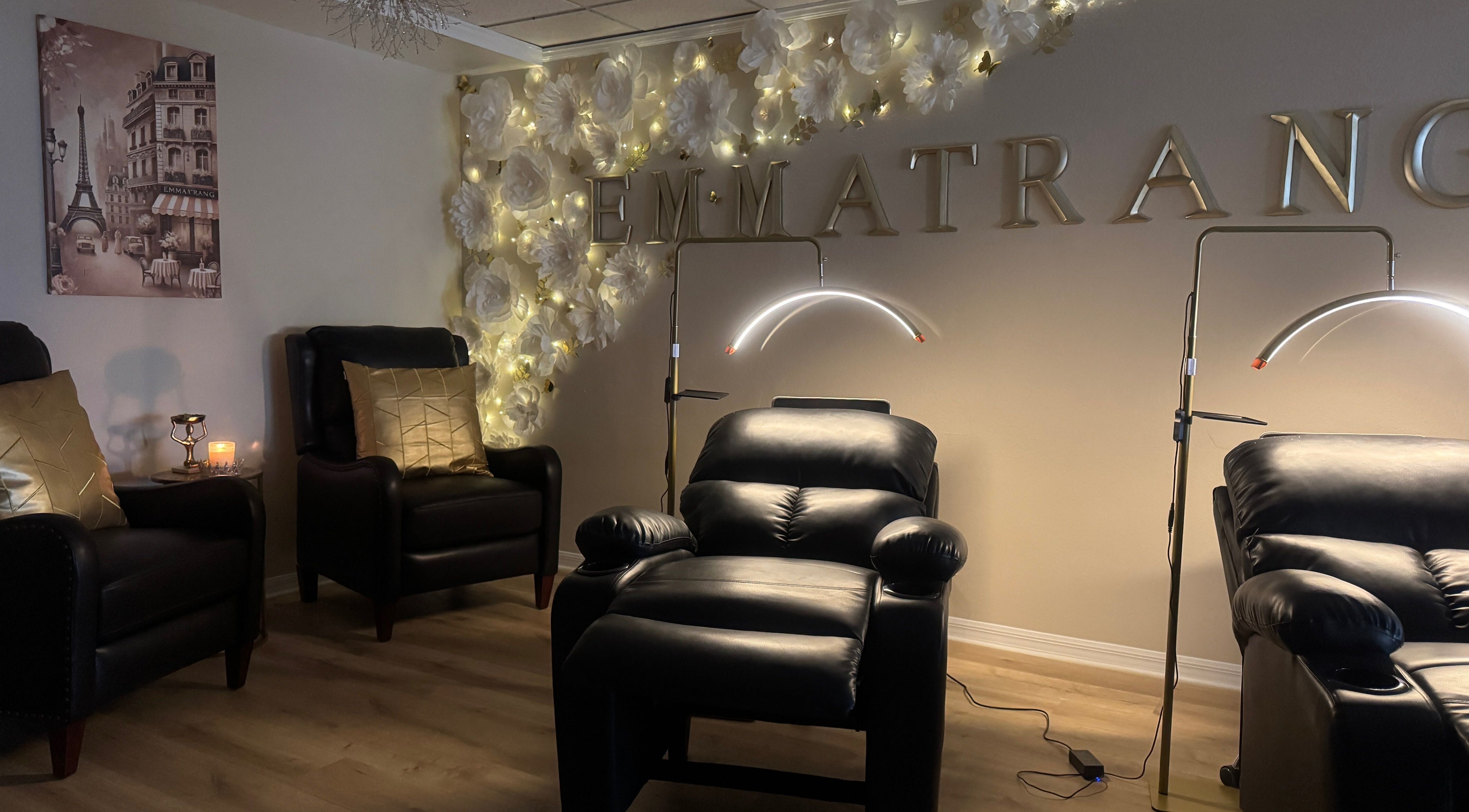 Luxurious seating area at Emma Trang Beauty, Venice, Florida, US with warm lighting and elegant decor.