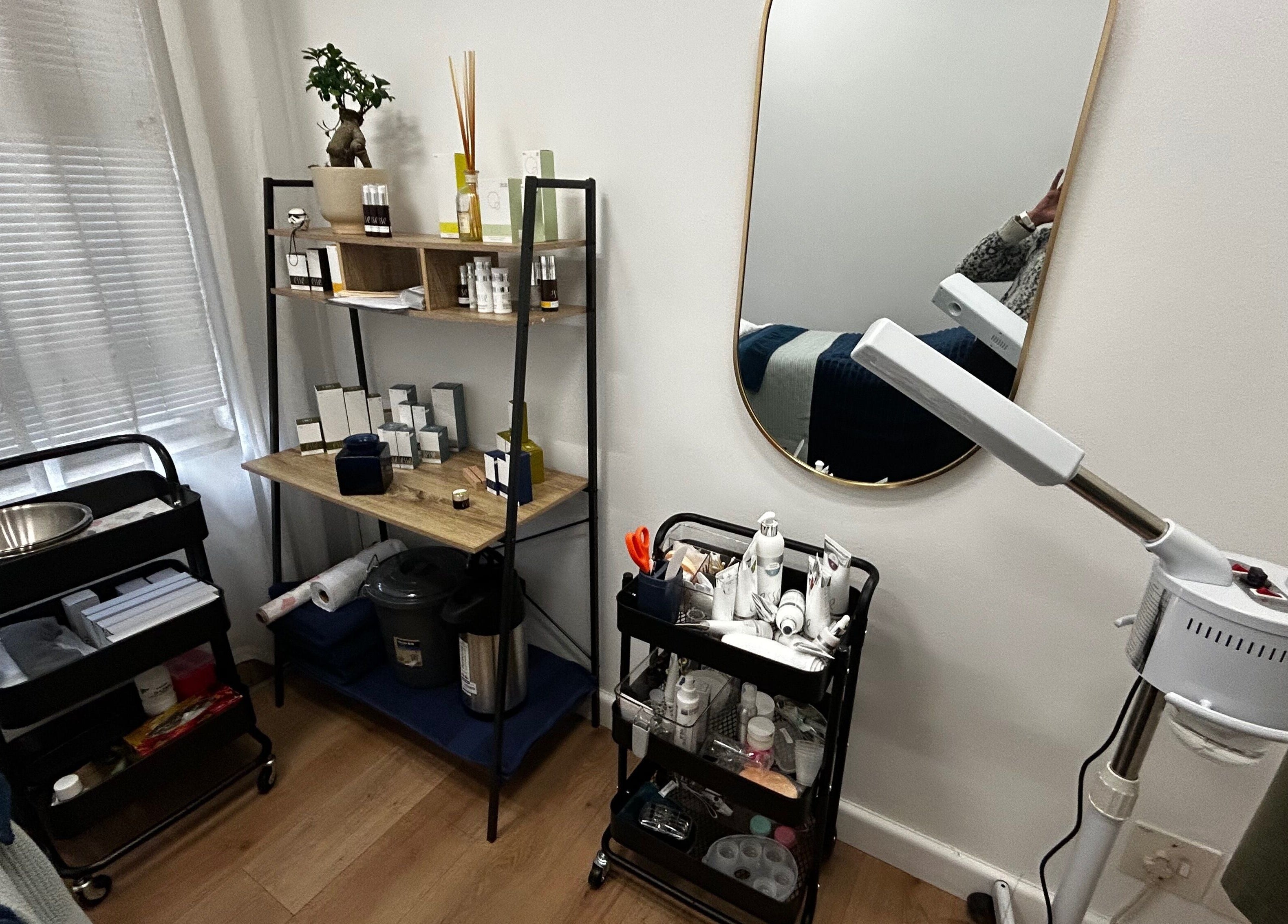 Cozy and organized treatment area at Skin Reboot, Cape Town, Western Cape, ZA, featuring skincare products and tools.