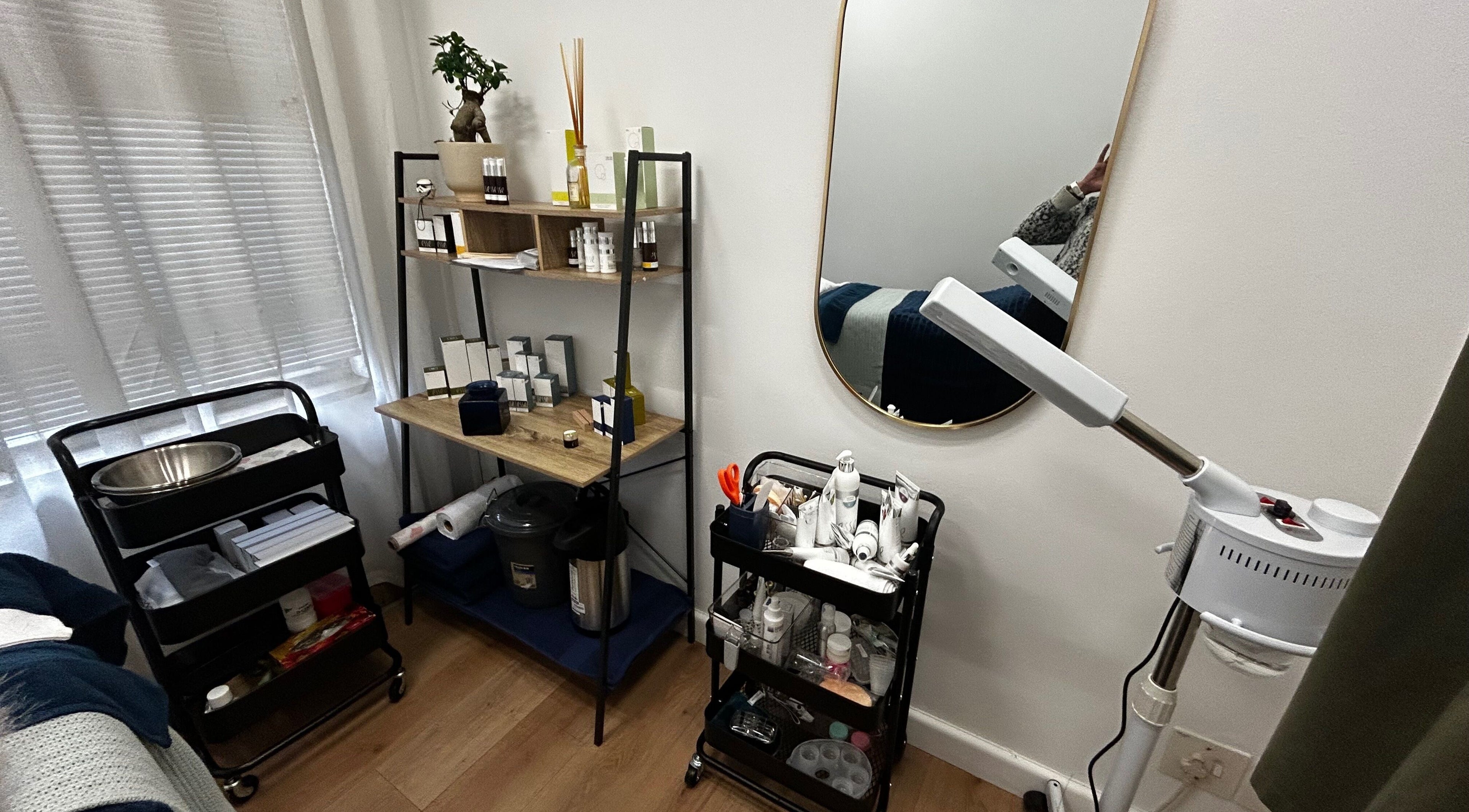 Cozy and organized treatment area at Skin Reboot, Cape Town, Western Cape, ZA, featuring skincare products and tools.