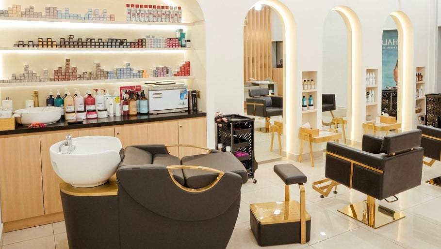 Elegant interior of Fresh N Fab Hair Beauty Ladies Salon in Dubai, Dubai, AE with modern chairs and product shelves.
