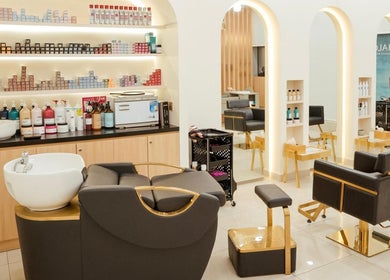 Elegant interior of Fresh N Fab Hair Beauty Ladies Salon in Dubai, Dubai, AE with modern chairs and product shelves.