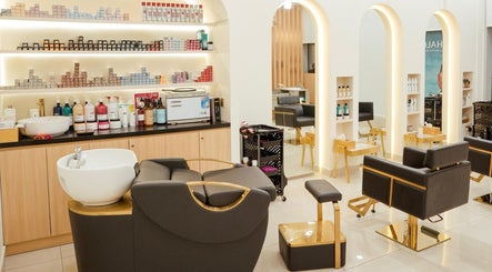 Elegant interior of Fresh N Fab Hair Beauty Ladies Salon in Dubai, Dubai, AE with modern chairs and product shelves.