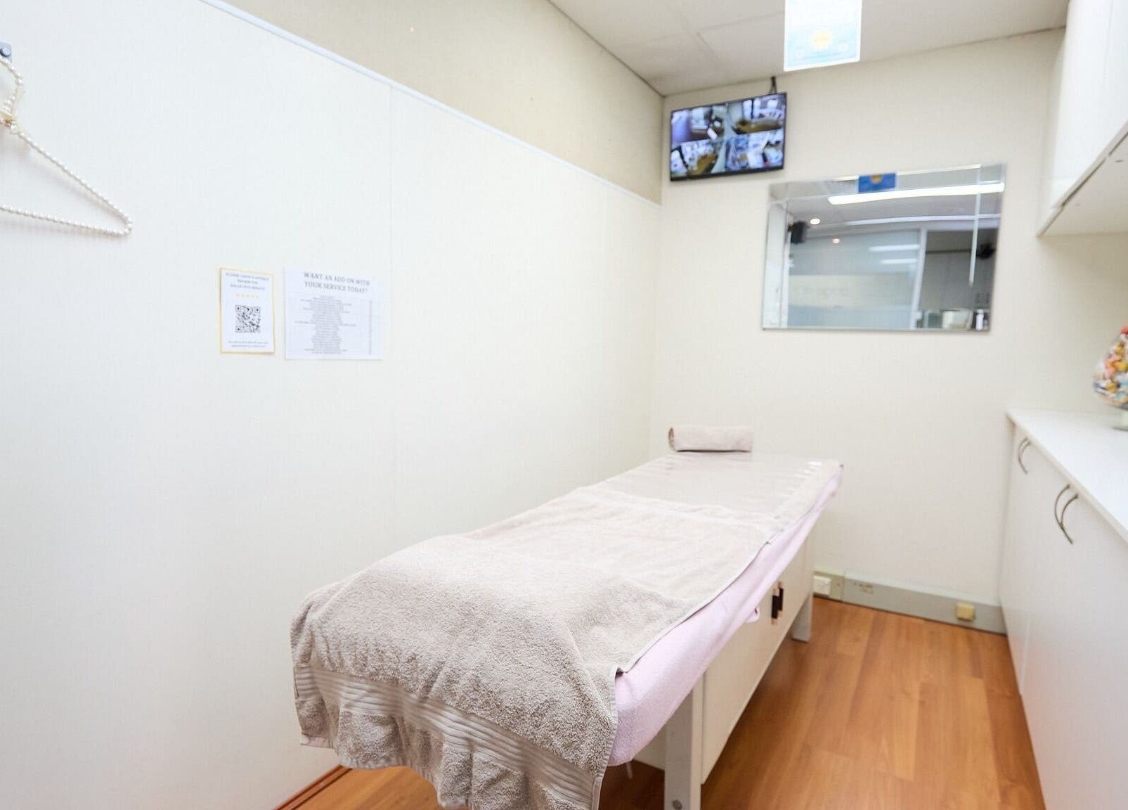 Calming treatment room at Dolce Vita Beaute, Newtown, New South Wales, AU, featuring a plush massage table.