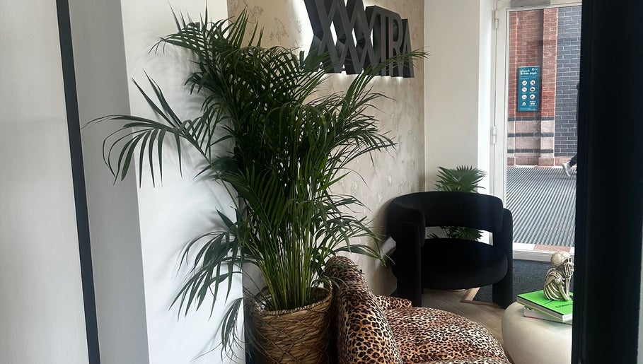 Stylish lounge at Made By Mel, Livingston, Scotland, GB with lush plants and modern decor.