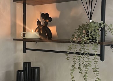 Elegant shelf decor with plant and candle at Made By Mel, Livingston, Scotland, GB.