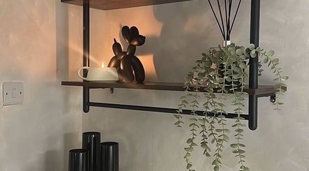 Elegant shelf decor with plant and candle at Made By Mel, Livingston, Scotland, GB.