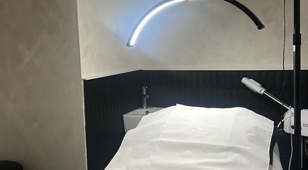 Treatment room at Made By Mel, Livingston, Scotland, GB, featuring a cozy bed under soft lighting.