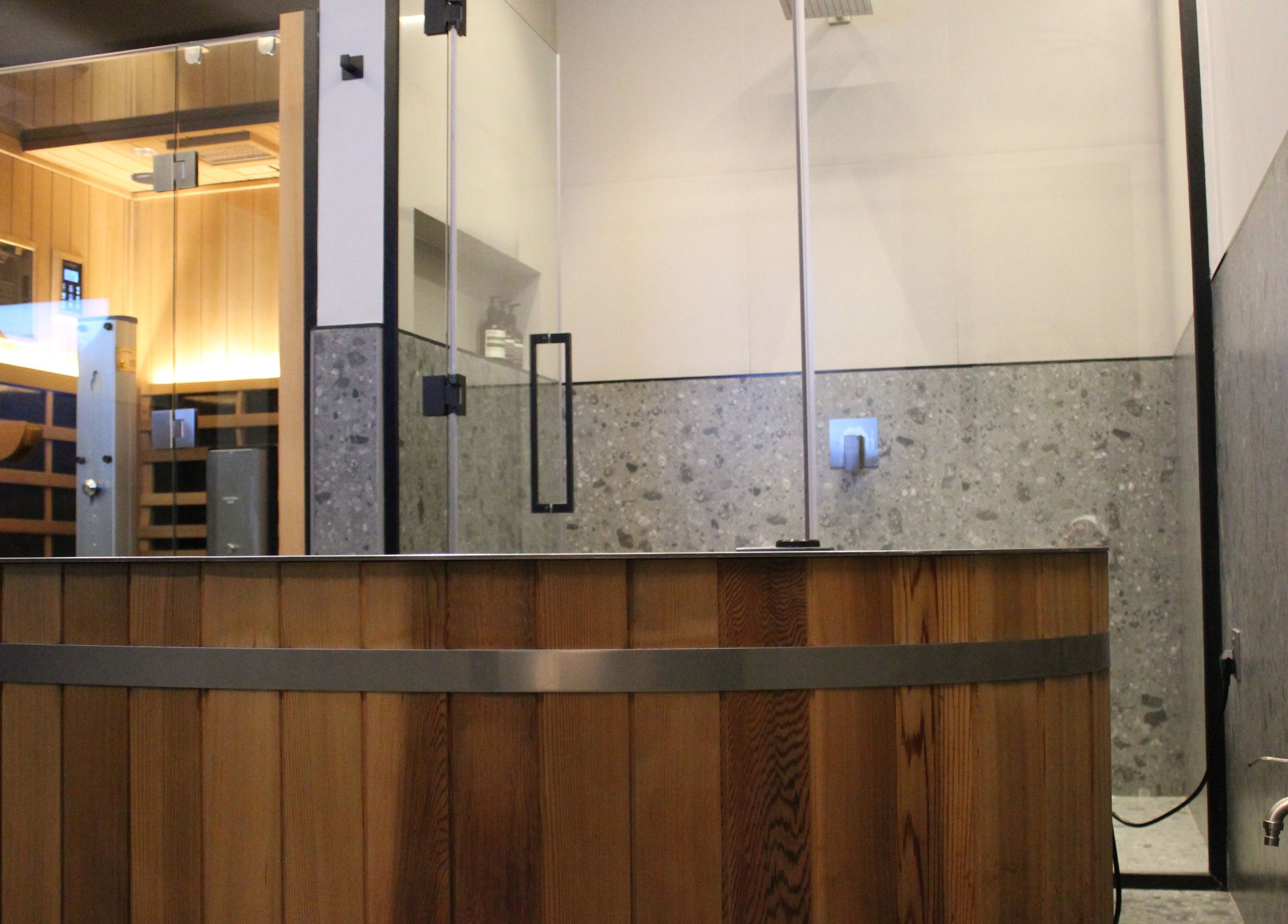 Relaxing sauna room at Beit Sisu in Dubai, Dubai, AE, featuring modern glass and wood design.