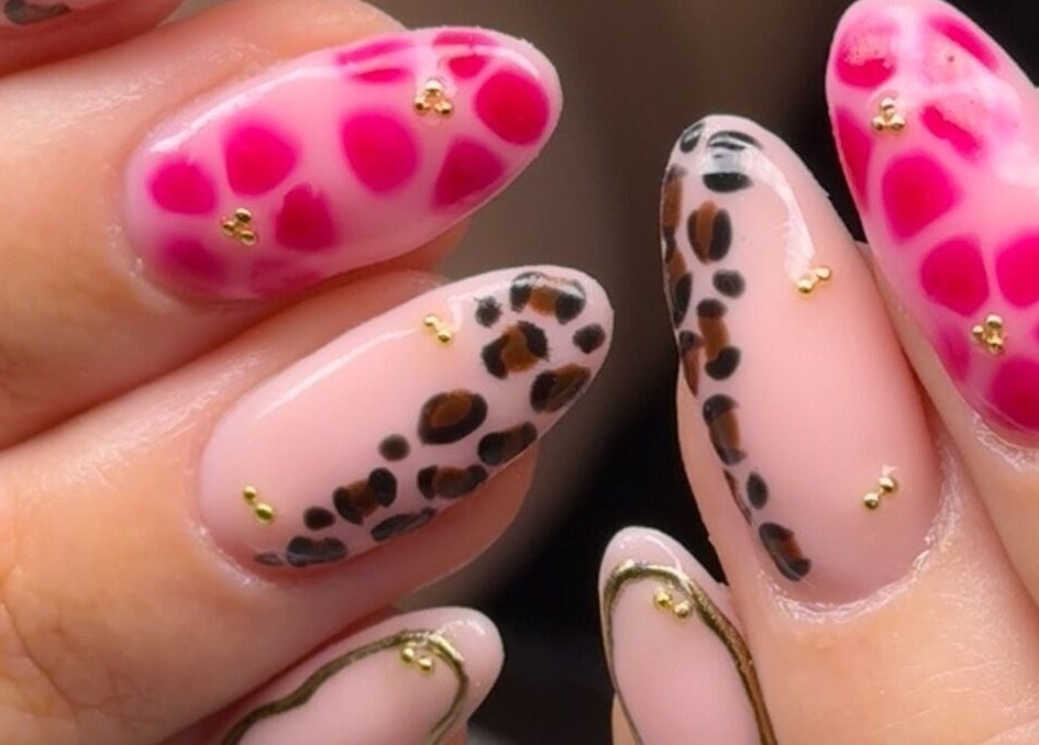 Vibrant nail art at Nailed It Bc, Hereford, England, GB showcasing cheetah and abstract patterns.