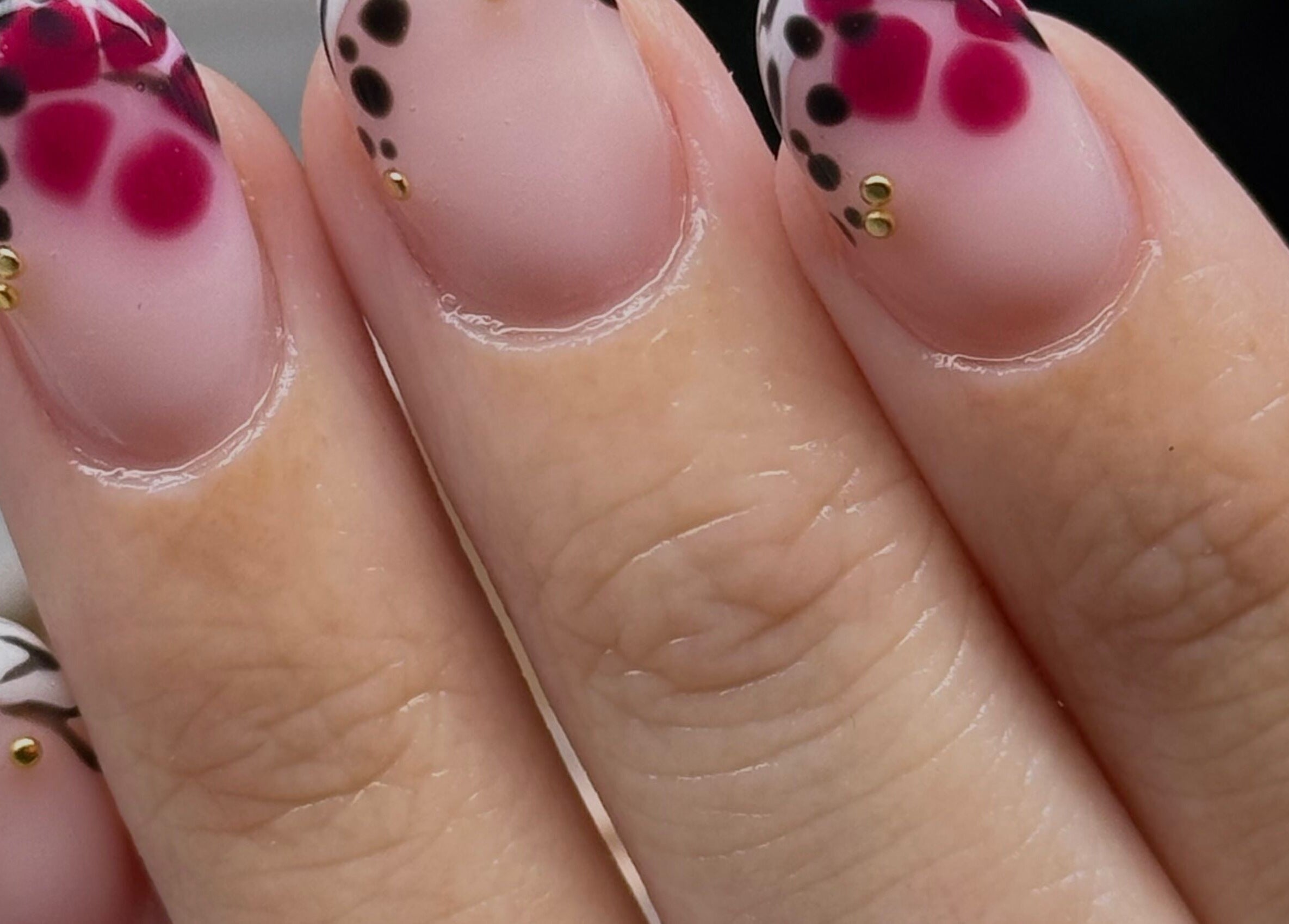 Stylish nail art with pink and black dots at Nailed It Bc, Hereford, England, GB.