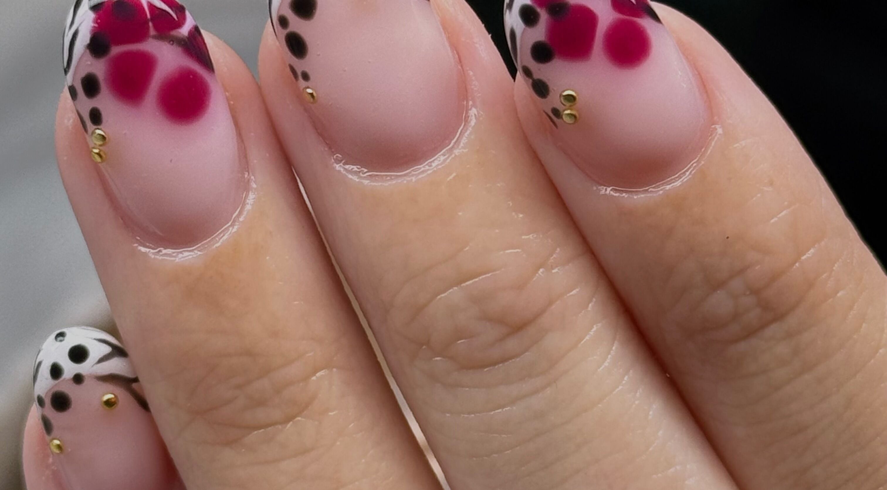 Stylish nail art with pink and black dots at Nailed It Bc, Hereford, England, GB.