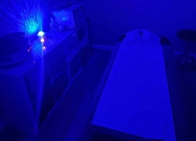 Calming massage room with blue lighting at Self Care Holistics and Therapies, Liverpool, England, GB.