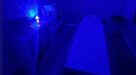 Calming massage room with blue lighting at Self Care Holistics and Therapies, Liverpool, England, GB.