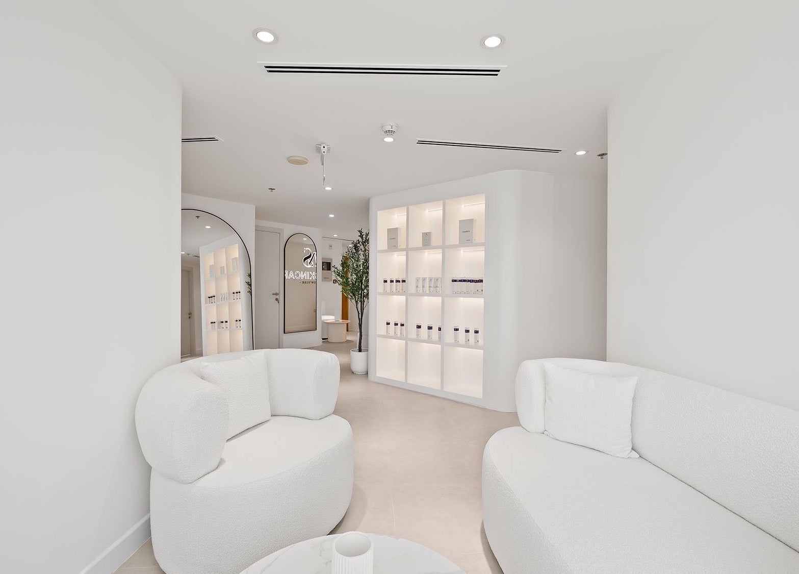 Sleek white interior of Nush Skincare Dubai, offering modern elegance in Dubai, Dubai, AE.