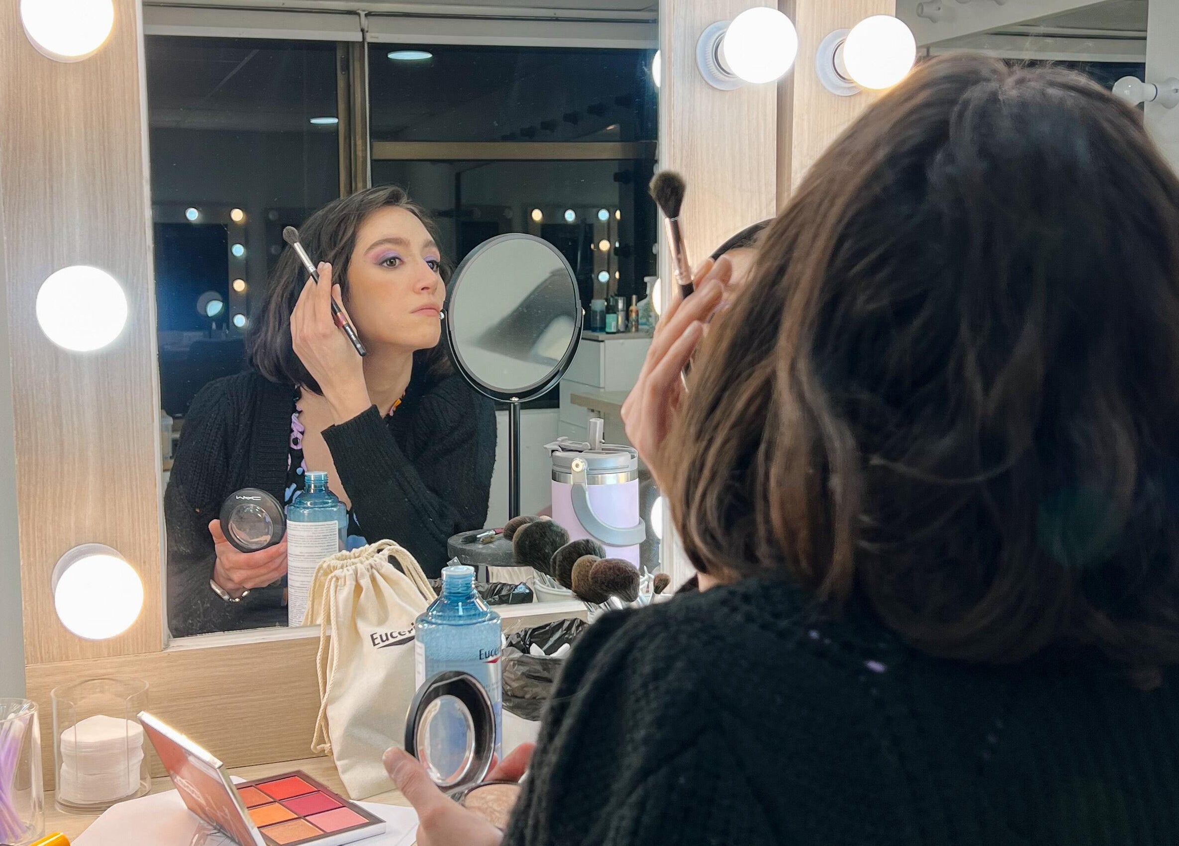 Persona maquillándose en The Beauty Room, Las Condes, Región Metropolitana, CL con espejo iluminado.