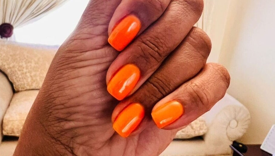 Bright orange nails at Nomsa's Nails and Beauty, Midrand, Gauteng, ZA, showcasing expert manicure.
