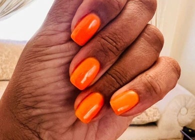 Bright orange nails at Nomsa's Nails and Beauty, Midrand, Gauteng, ZA, showcasing expert manicure.