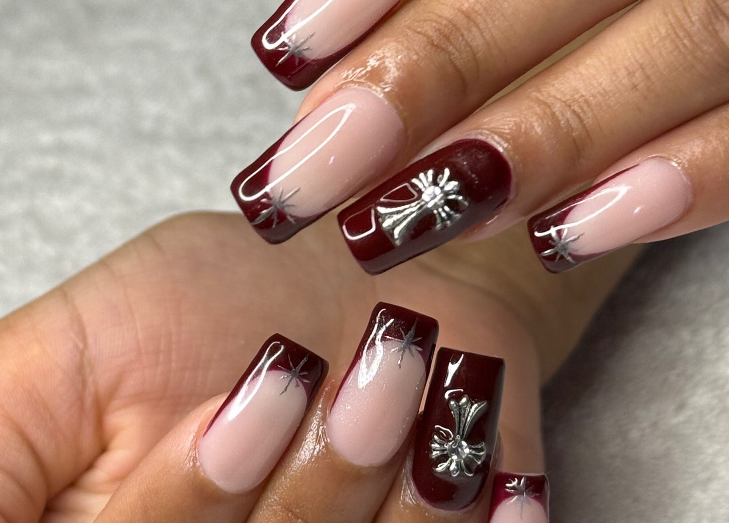 Beautifully manicured nails with red and silver designs at Nails by Teri, Queensburgh, Kwazulu-natal, ZA.