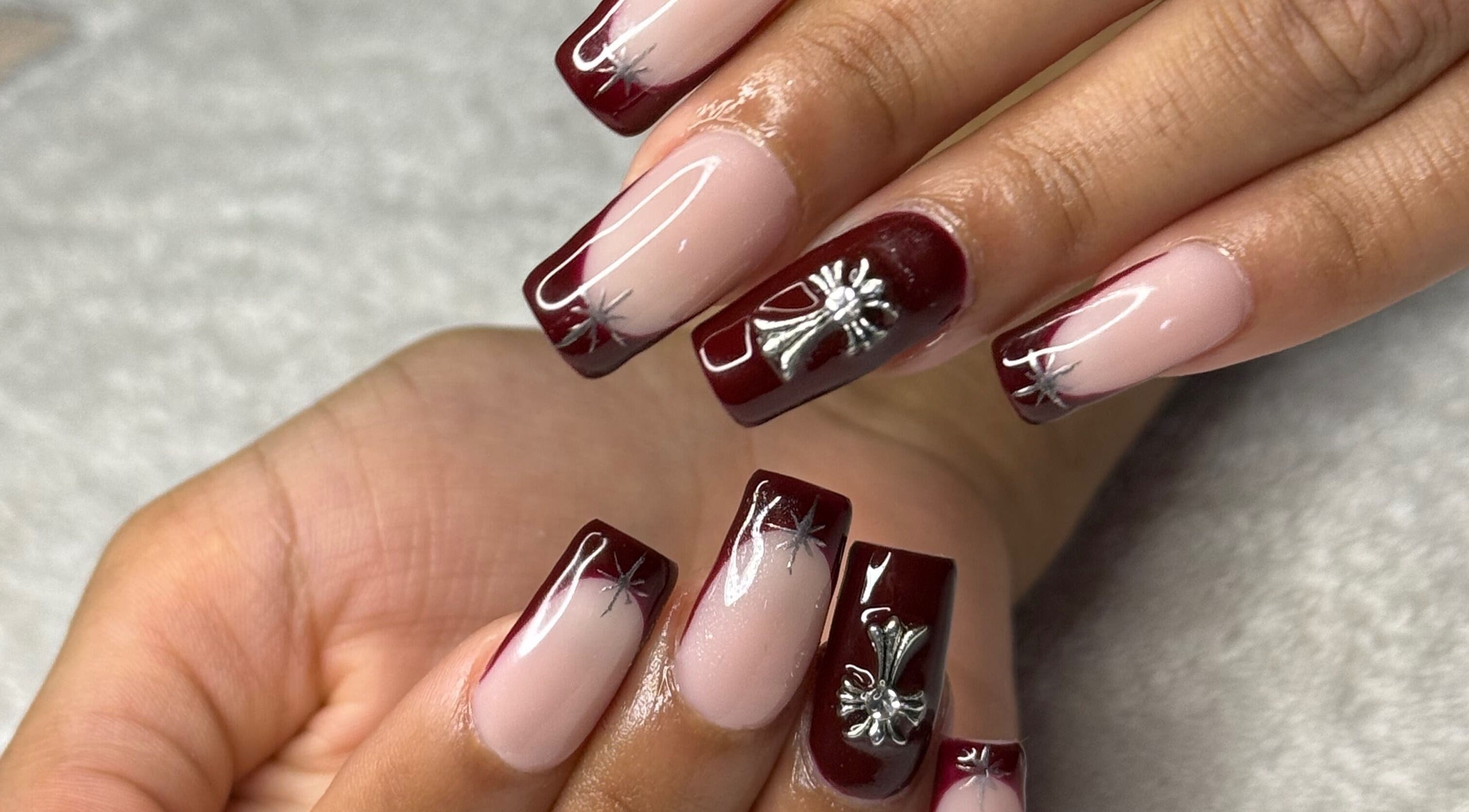 Beautifully manicured nails with red and silver designs at Nails by Teri, Queensburgh, Kwazulu-natal, ZA.