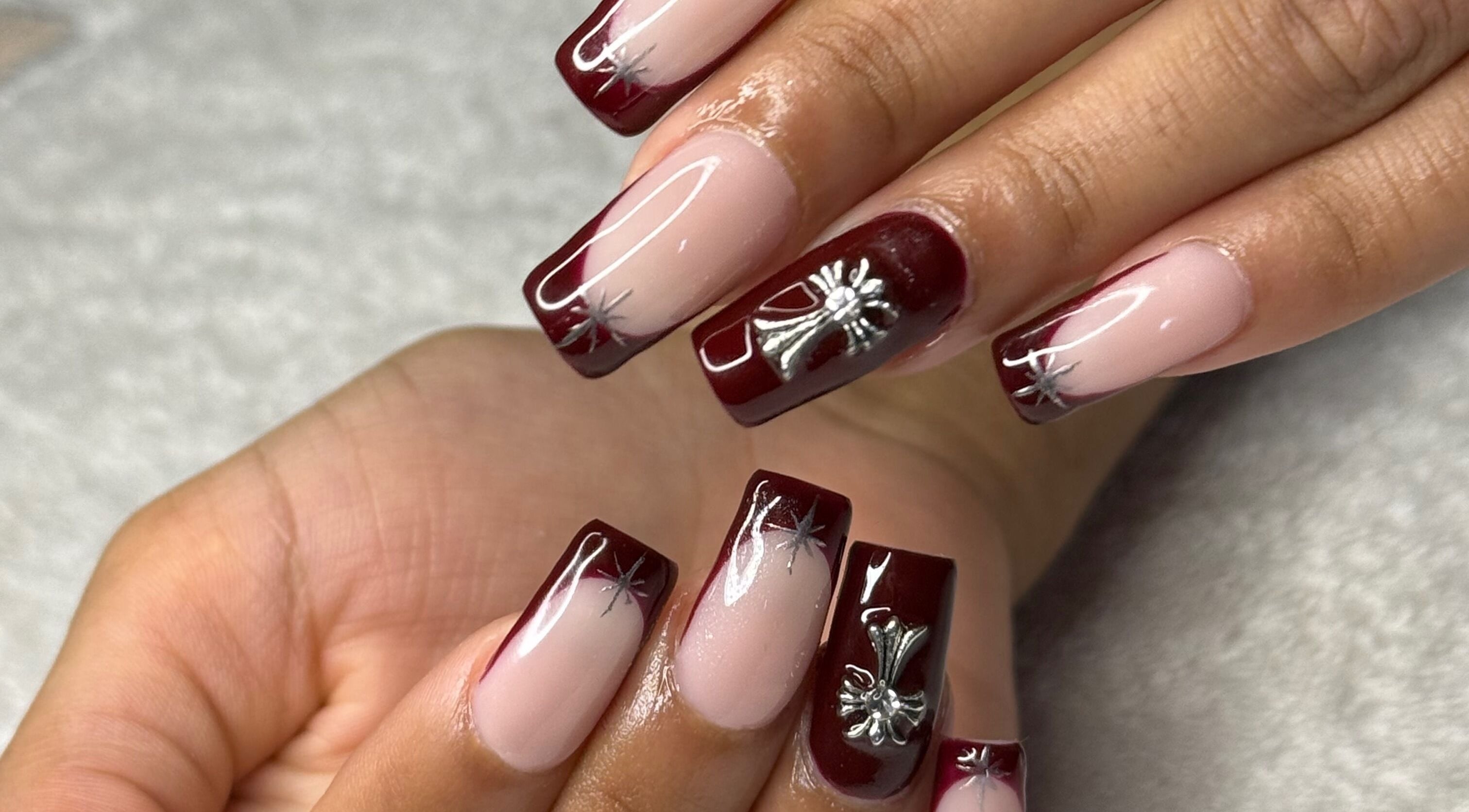 Beautifully manicured nails with red and silver designs at Nails by Teri, Queensburgh, Kwazulu-natal, ZA.